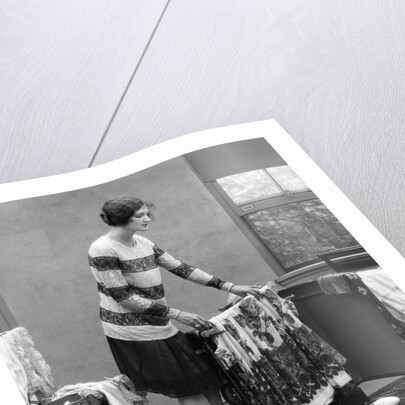 1920s woman packing clothes for travel by Anonymous