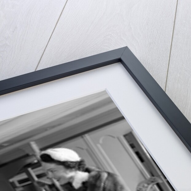 1950s woman in hat stole & gloves taking hatbox from saleswoman by Anonymous