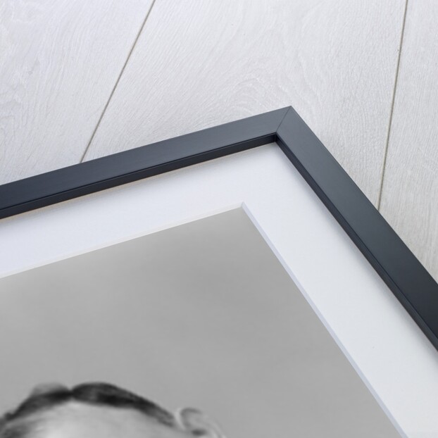 1940s 1950s perspiring man in rolled up shirt sleeves loosening tie holding handkerchief wiping forehead looking at camera by Anonymous