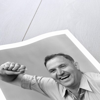 1940s 1950s portrait of man in shirt and tie holding handkerchief smiling by Anonymous