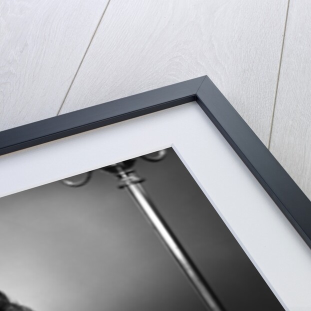 1950s woman crocheting baby sock looking at camera by Anonymous