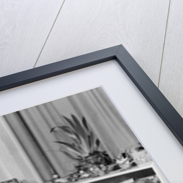 1950s 4 pre-school age children seated at small round table putting together jigsaw puzzle by Anonymous