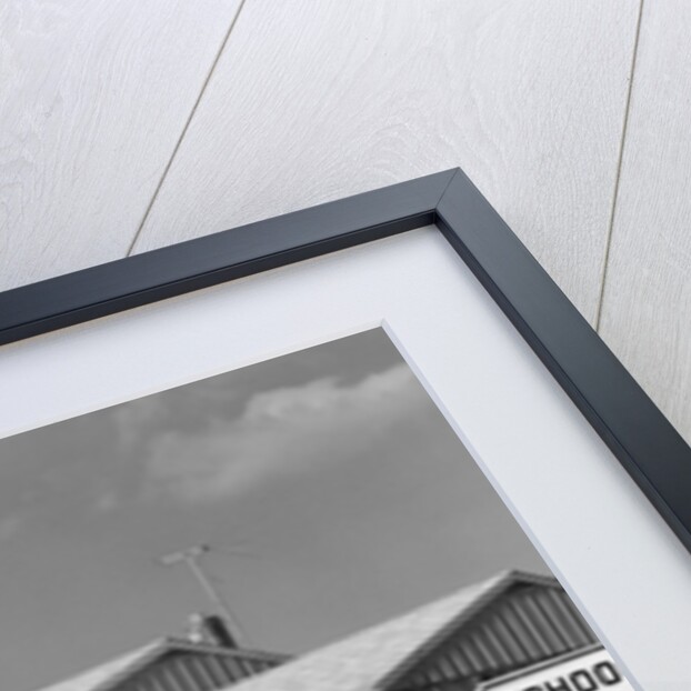 1950s back view of twin girls in plaid skirts & cardigans holding book bags running past school slow sign by Anonymous