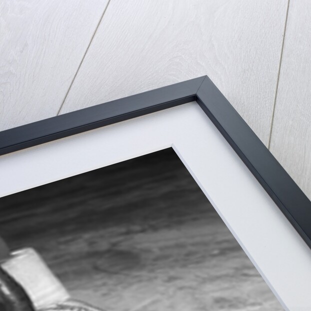 1940s 1950s close-up of padded goalie shown waist-down holding stick with puck in front of him by Anonymous