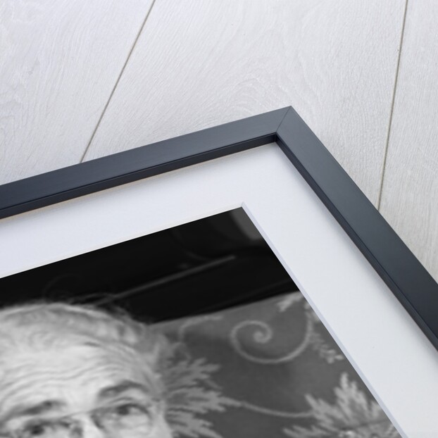 1960s elderly woman in polka-dotted dress & shawl reading letter by Anonymous