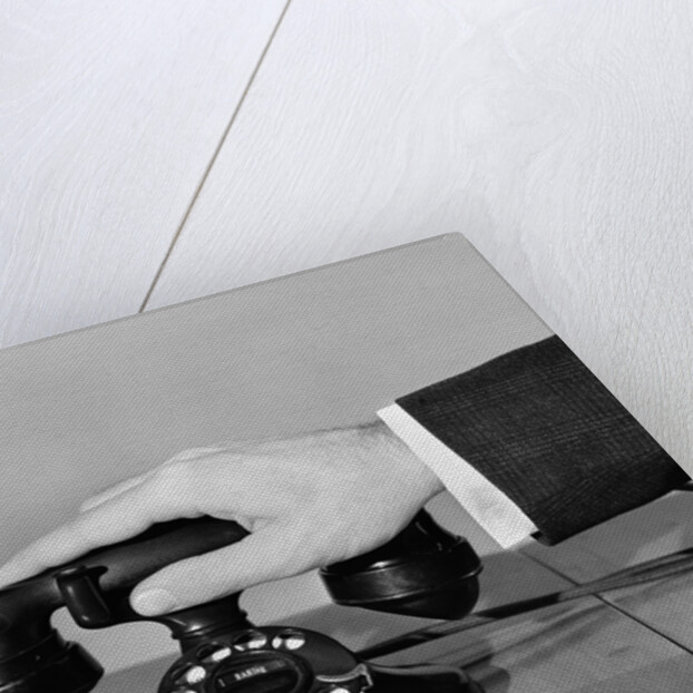 1930s 1940s man's hand on telephone by Anonymous
