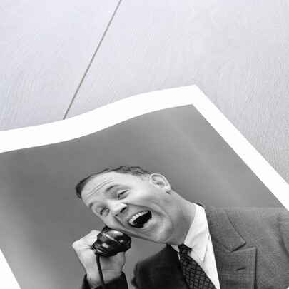 1930s man in suit laughing talking on telephone by Anonymous