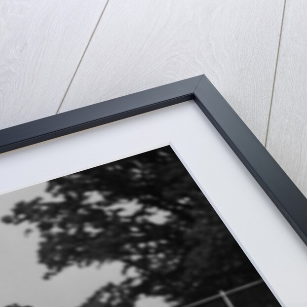 1930s man walking across tennis court holding tennis racket & balls by Anonymous