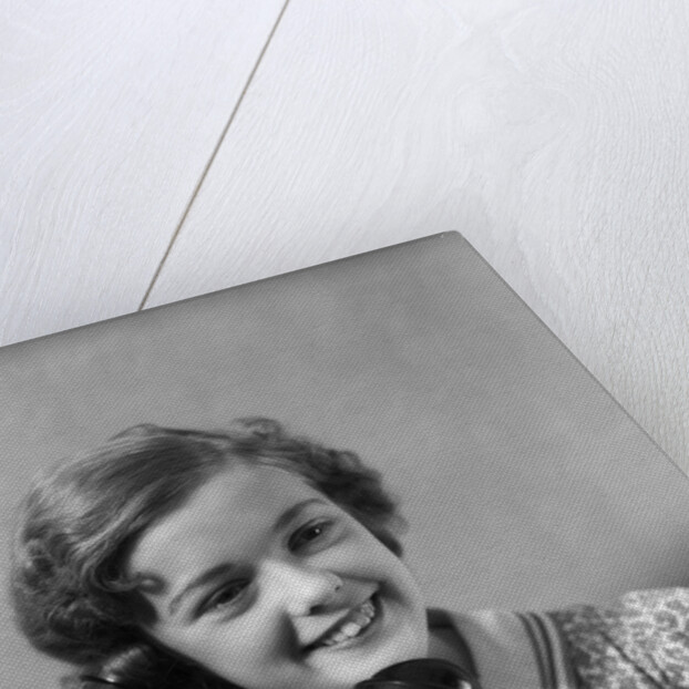 1930s teen girl smiling brunette print dress talking on telephone by Anonymous
