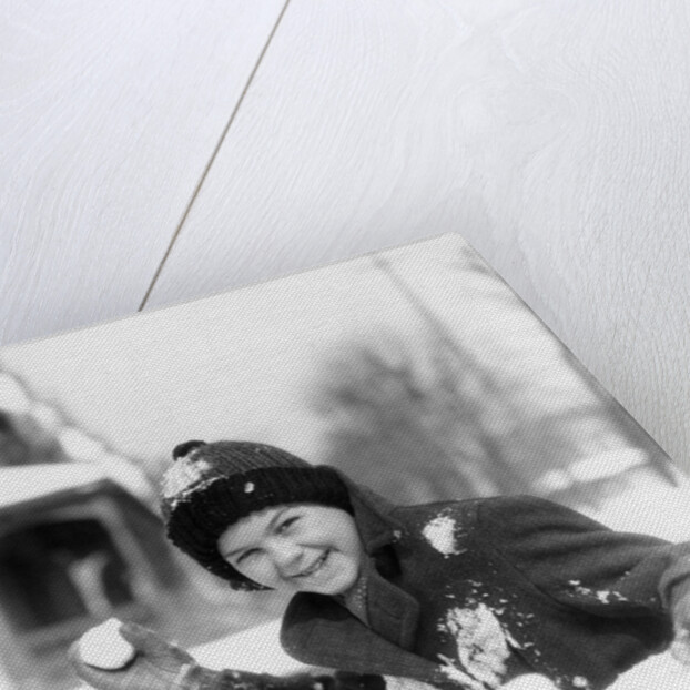 1920s 1930s smiling boy about to throw toss snowball playing snow fun winter cold mischief looking at camera by Anonymous