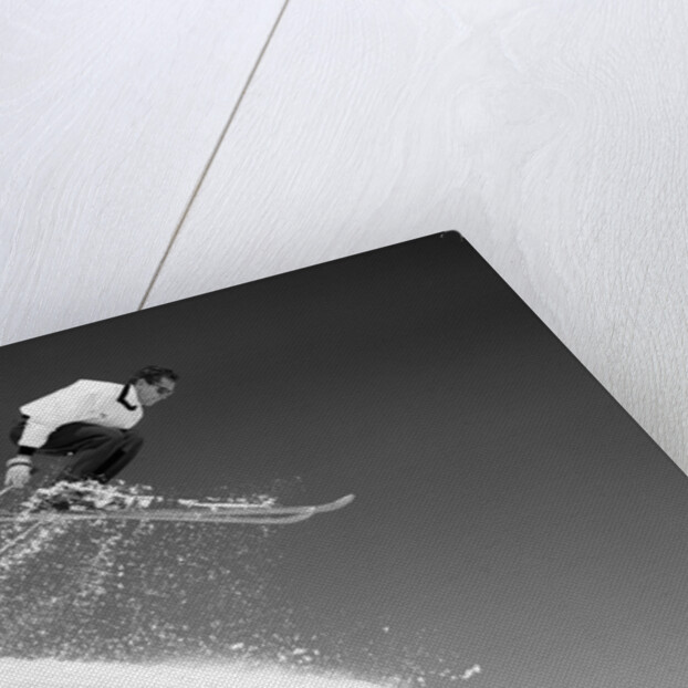 1950s man skier skiing down slope jumping into air by Anonymous