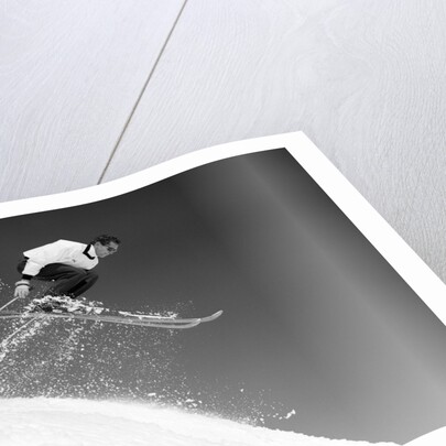 1950s man skier skiing down slope jumping into air by Anonymous