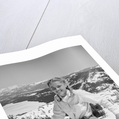 1940s 1950s young blond athletic woman looking at camera smiling standing with ski poles top of mountain by Anonymous