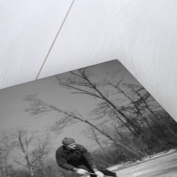 1940s man playing ice hockey on frozen lake controlling puck with stick by Anonymous