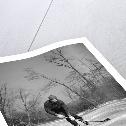 1940s man playing ice hockey on frozen lake controlling puck with stick by Anonymous