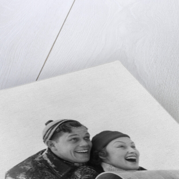 1930s couple on toboggan laughing by Anonymous
