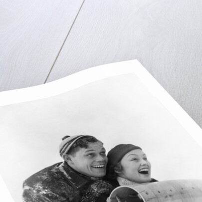 1930s couple on toboggan laughing by Anonymous