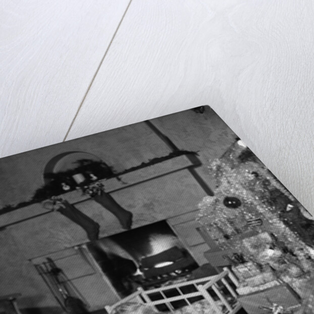 1950s smiling little girl christmas tree talking on toy telephone by Anonymous