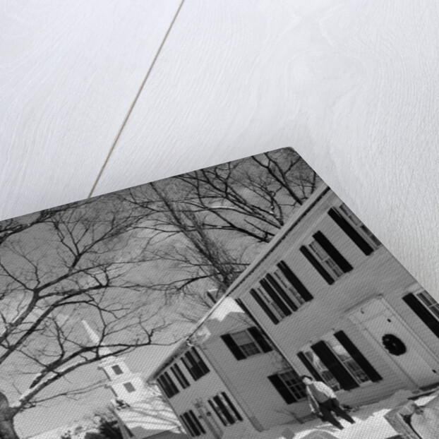 1960s woman walking to rural mailbox in front of home in snow piled with christmas packages by Anonymous