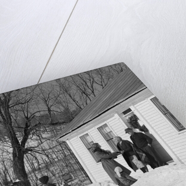 1950s family visiting relatives at christmas being greeted at front door by Anonymous