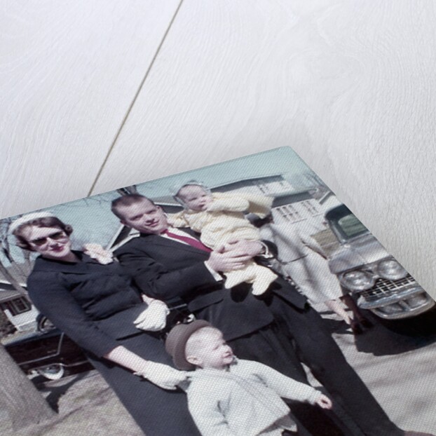 Young family dressed in the Sunday best, ca. 1960. by Anonymous