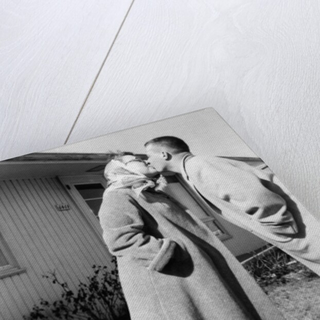 Young husband and wife kiss, ca. 1955. by Anonymous