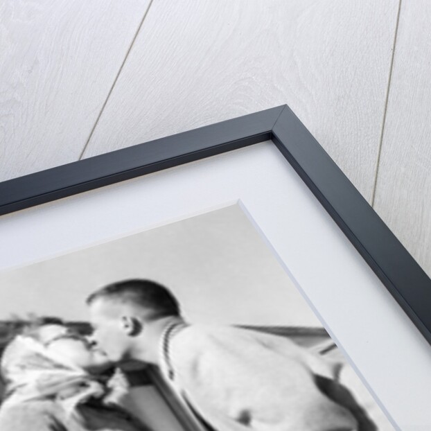 Young husband and wife kiss, ca. 1955. by Anonymous