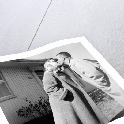 Young husband and wife kiss, ca. 1955. by Anonymous