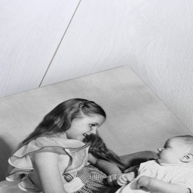 Big sister looks down on her baby brother, ca. 1948 by Anonymous