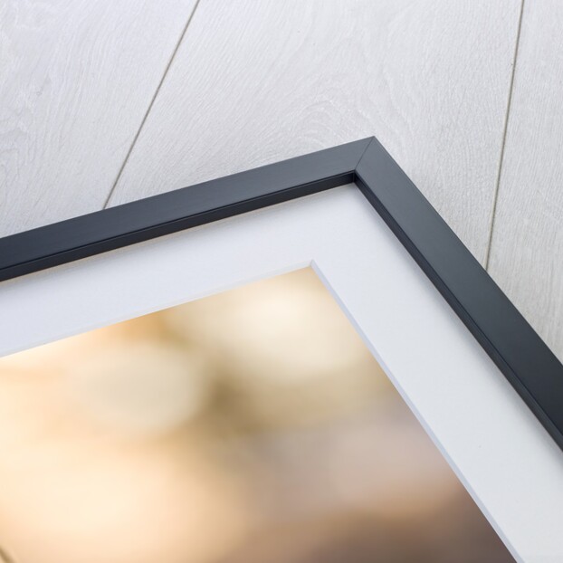 Close-up of golden Christmas tree on red bauble against blurred background by Anonymous