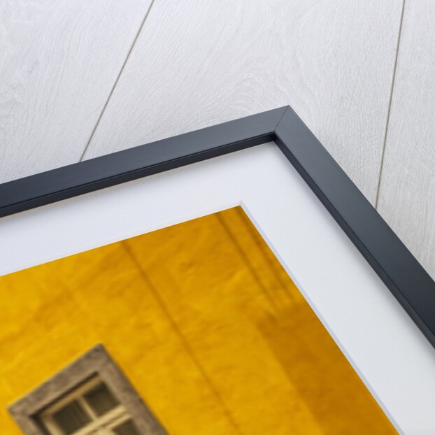 A street in Tavira leading to the entrance of a church by Anonymous