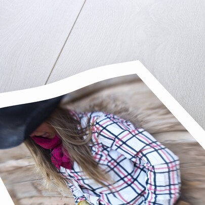 Cowgirl outside cabin by Anonymous