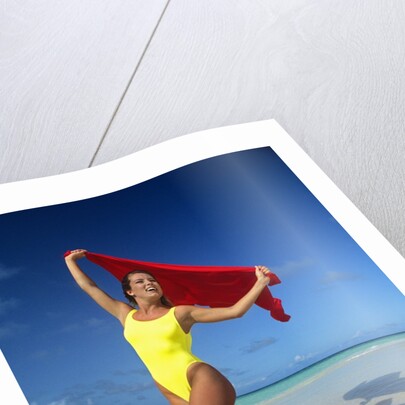 1990s Woman In Yellow Bathing Suit Holding Windblown Red Cloth Mopion Island, Grenadines, West Indies by Anonymous