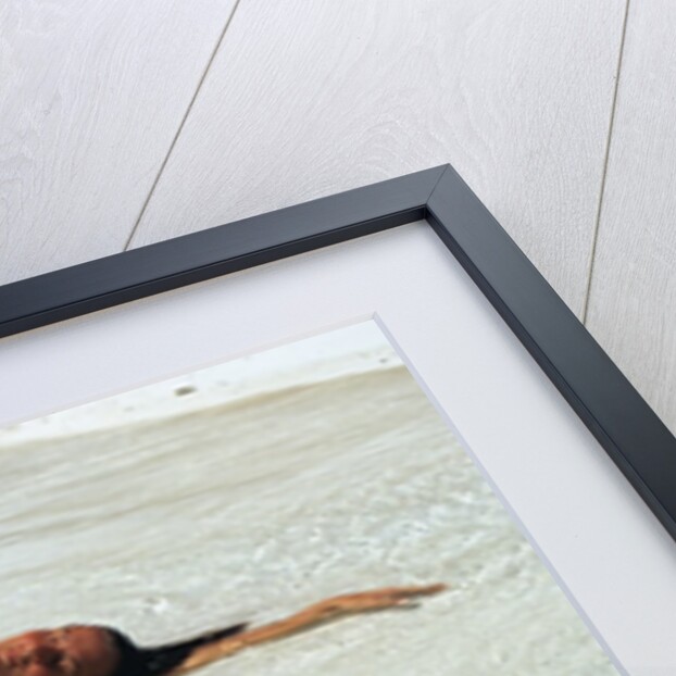 1990s Woman In Red Bikini Lying In Shallow Water On The Beach by Anonymous