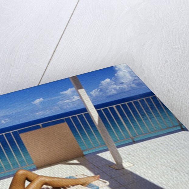 1990s Woman Wearing Black And Gold Bathing Suit Sunbathing On Patio In Deck Chair by Anonymous