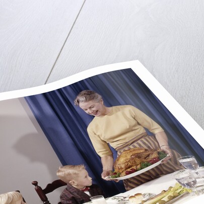 1960s Grandmother Presenting Roasted Turkey To Children At Dining Room Table by Anonymous