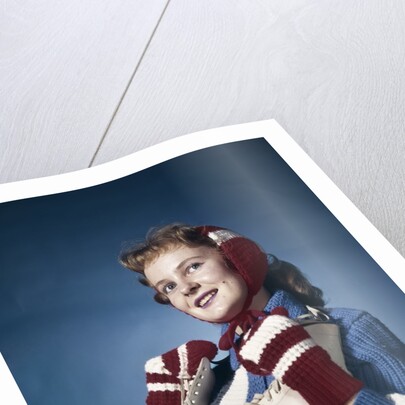 1960s Smiling Woman Wearing Red Mittens Ear Muff Blue Sweater Holding Ice Skates by Anonymous