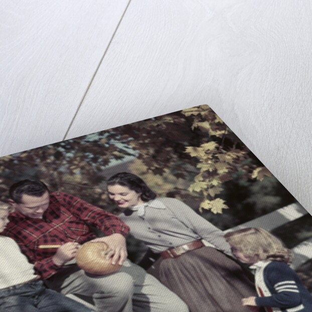 1950s Family Father Mother Son And Daughter Outdoor Carving A Pumpkin by Anonymous