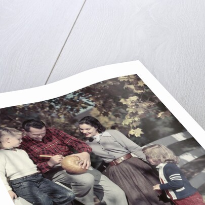 1950s Family Father Mother Son And Daughter Outdoor Carving A Pumpkin by Anonymous