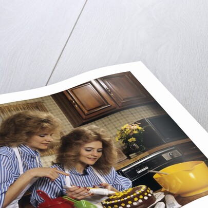 1970s Mother Daughter Dressed Alike Decorating Cake by Anonymous