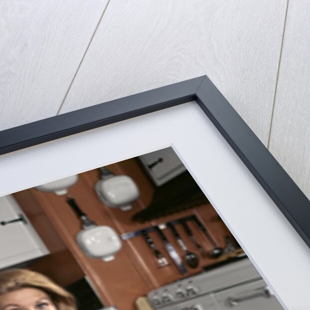 1960s Young Smiling Blond Housewife Sitting On Top Of Laundry Basket Kitchen by Anonymous