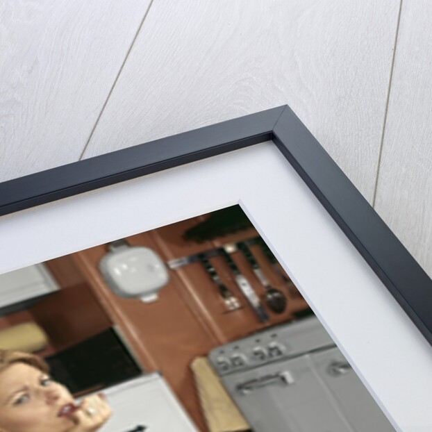 1960s Tired Housewife Sitting On Top Of Laundry Basket In Kitchen by Anonymous