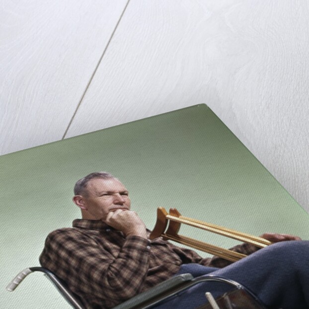 1960 1960s Retro Senior Man Sitting In Wheelchair With Crutches Blanket Wrapped Around Legs by Anonymous