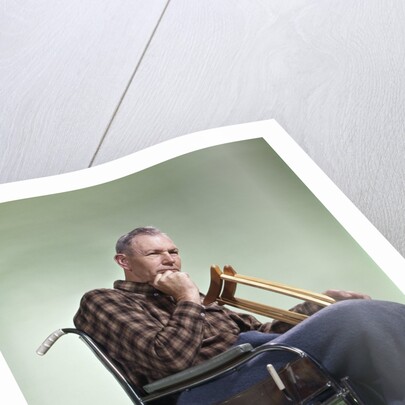1960 1960s Retro Senior Man Sitting In Wheelchair With Crutches Blanket Wrapped Around Legs by Anonymous