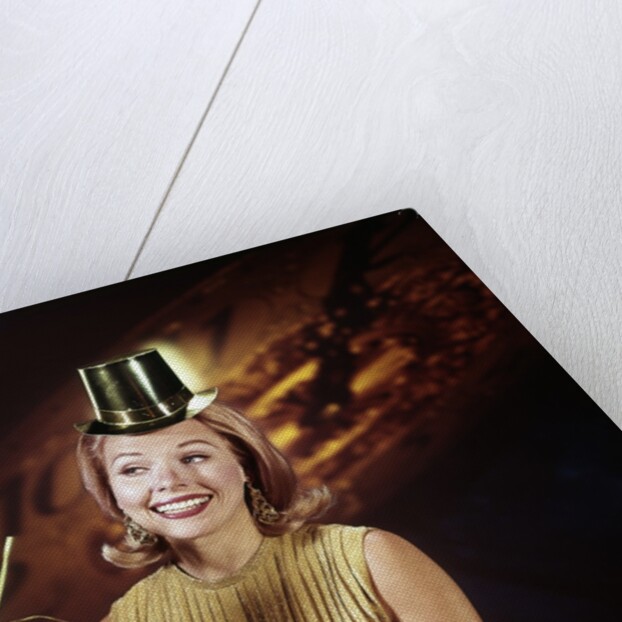 1960s Young Blonde Woman Party Hat Noisemaker Horn Smiling New Year Clock Background by Anonymous