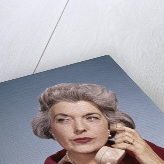 1960s Senior Middle Aged Woman Red Blouse Serious Expression Talking On Telephone by Anonymous