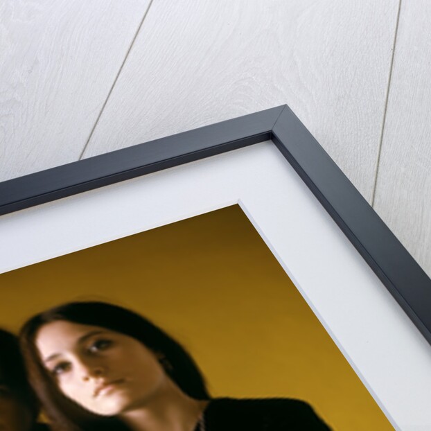 1960s 1970s Young Couple Man Woman Head To Head Dressed In Black Look At Camera Mod Style Serious Expression Blur Lights by Anonymous