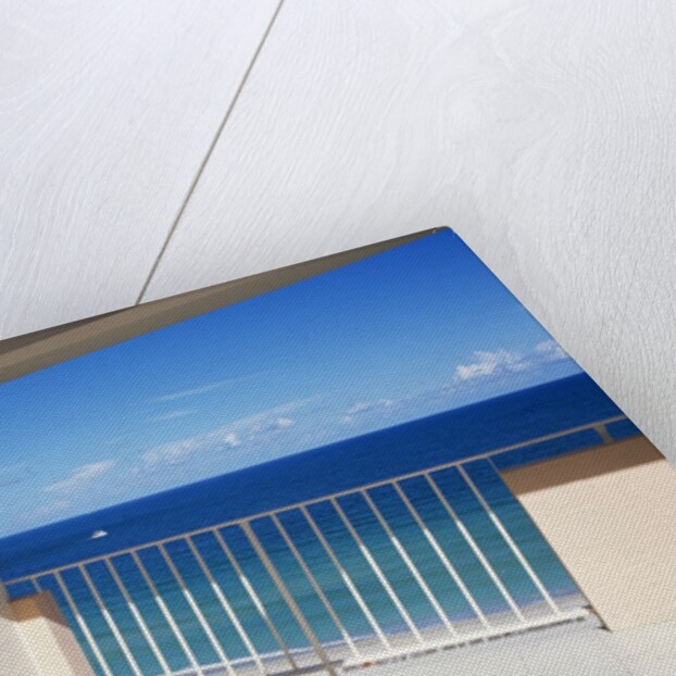 1990s Man In Dark Suit And Tie And Woman In White One Piece Bathing Suit Standing Together On Ocean Side Sun Deck by Anonymous