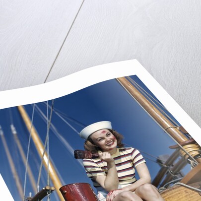 1940s Smiling Woman Wearing Nautical Sailor Outfit And Hat Sitting On Edge Of Boat Holding Paint Brush by Anonymous