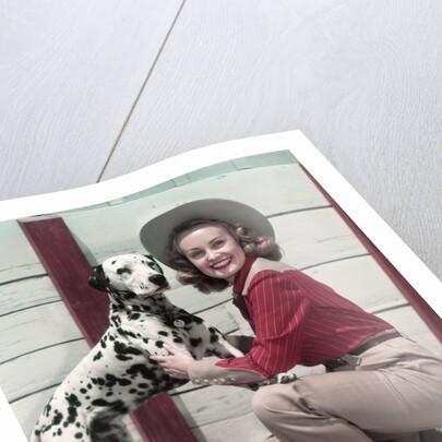 1940s 1950s Smiling Woman Wearing Western Cowgirl Outfit Kneeling Petting Dalmatian Dog by Anonymous